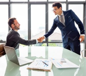 A confident handshake across a sunlit boardroom table conveys the collaborative strategy session waiting behind your CTA link.